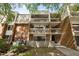 Brick condo building with multiple balconies and well-maintained landscaping at 500 Umstead Dr # 103C, Chapel Hill, NC 27516