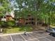 Apartment complex with balconies, surrounded by mature trees and visible parking at 500 Umstead Dr # 103C, Chapel Hill, NC 27516