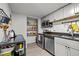 Efficient kitchen design with white cabinets and stainless steel appliances at 500 Umstead Dr # 103C, Chapel Hill, NC 27516
