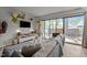 Cozy living room showcasing a sectional sofa, TV, and sliding glass doors leading to outdoor area at 500 Umstead Dr # 103C, Chapel Hill, NC 27516