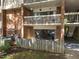 Lower level patio features fenced surround and sliding glass door access to living space at 500 Umstead Dr # 103C, Chapel Hill, NC 27516
