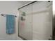 Well-maintained shower with glass doors and integrated shelving for toiletries and personal care items at 500 Umstead Dr # 103C, Chapel Hill, NC 27516