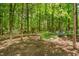 Scenic backyard boasts a lovely hammock, rock garden, wooded area, and is perfect for peaceful relaxation at 6 Gasper Ct, Durham, NC 27713