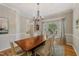 Elegant dining room featuring a chandelier, a wooden table, and a bay window with lots of natural light at 6 Gasper Ct, Durham, NC 27713