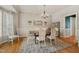 Elegant dining room with hardwood floors, a chandelier, and a large window for natural light at 6 Gasper Ct, Durham, NC 27713