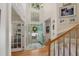 Bright foyer with hardwood floors, a staircase, and a view of the front door with a decorative wreath at 6 Gasper Ct, Durham, NC 27713