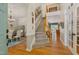 Grand foyer with hardwood floors, a staircase, and an open view into the dining and living areas at 6 Gasper Ct, Durham, NC 27713