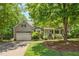 Charming two-story home with a covered front porch, manicured landscaping, and an attached two-car garage at 6 Gasper Ct, Durham, NC 27713