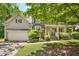 Charming two-story home with a covered front porch, manicured landscaping, and an attached two-car garage at 6 Gasper Ct, Durham, NC 27713