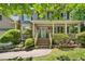 Inviting front porch with brick steps, well-maintained landscaping, and a decorative wreath on the teal front door at 6 Gasper Ct, Durham, NC 27713