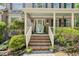 Inviting front porch with brick steps, decorative wreath on the door, and well-maintained landscaping at 6 Gasper Ct, Durham, NC 27713