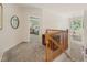 Second-floor hallway with carpet floors overlooking the foyer through the wooden railing at 6 Gasper Ct, Durham, NC 27713