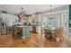 Well-lit kitchen and breakfast nook featuring modern stainless steel appliances and a central island, perfect for cooking at 6 Gasper Ct, Durham, NC 27713
