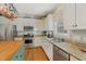 Well-lit kitchen with stainless steel appliances, granite countertops, and wood flooring at 6 Gasper Ct, Durham, NC 27713