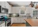 Modern kitchen featuring stainless steel appliances, granite counters, a butcher block island, and ample cabinet space at 6 Gasper Ct, Durham, NC 27713