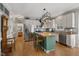Spacious kitchen featuring white cabinets, stainless steel appliances, an island, and a connected breakfast nook at 6 Gasper Ct, Durham, NC 27713