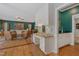 Living room with office space transitions to the kitchen, offering an open layout, hardwood floors and natural light at 6 Gasper Ct, Durham, NC 27713