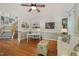 Inviting living room featuring hardwood floors, a ceiling fan, and a comfortable white sofa at 6 Gasper Ct, Durham, NC 27713