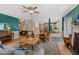 Open-concept living room featuring hardwood floors, a fireplace, and seamless transition into the dining and kitchen areas at 6 Gasper Ct, Durham, NC 27713