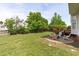 Spacious backyard with a patio, deck, and lush green lawn at 6002 Whisperwood Dr, Durham, NC 27713