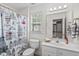 Bright bathroom features a Paris themed shower curtain and a large mirror at 6002 Whisperwood Dr, Durham, NC 27713