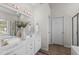 Bright bathroom with a double vanity, decorative vases, and an abundance of counter space at 6002 Whisperwood Dr, Durham, NC 27713