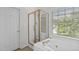 Bathroom with a shower stall and a large tub under a window with wood blinds at 6002 Whisperwood Dr, Durham, NC 27713