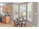 Bright eat-in kitchen dining area with large windows and hardwood flooring at 6002 Whisperwood Dr, Durham, NC 27713