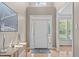 Bright and airy foyer featuring a light neutral color palette and hardwood flooring at 6002 Whisperwood Dr, Durham, NC 27713