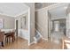 Inviting home foyer showcasing hardwood floors, staircase, and seamless flow into the dining and living areas at 6002 Whisperwood Dr, Durham, NC 27713