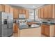 Well-equipped kitchen boasts stainless steel appliances, wood cabinets, and island prep space at 6002 Whisperwood Dr, Durham, NC 27713