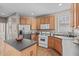 Clean kitchen featuring stainless steel appliances, ample counter space, and wood-finished cabinetry at 6002 Whisperwood Dr, Durham, NC 27713