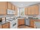 Neat kitchen with wooden cabinets, stainless steel appliances, and efficient counter space at 6002 Whisperwood Dr, Durham, NC 27713