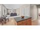 Open-concept eat-in kitchen and living room boasts fireplace and hardwood flooring at 6002 Whisperwood Dr, Durham, NC 27713