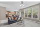 Inviting living room featuring a comfortable sofa, bright windows, and an open layout to the kitchen at 6002 Whisperwood Dr, Durham, NC 27713