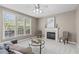 Cozy living room with a fireplace, neutral color palette, plush carpeting, and abundant natural light at 6002 Whisperwood Dr, Durham, NC 27713