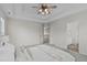 Bright and airy main bedroom showing a glimpse of the upstairs landing and ensuite bath at 6002 Whisperwood Dr, Durham, NC 27713