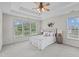 The bright, primary bedroom with a trey ceiling has a large window overlooking the backyard at 6002 Whisperwood Dr, Durham, NC 27713