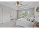 This bedroom offers neutral walls, a ceiling fan, and a peak at the ensuite bathroom at 6002 Whisperwood Dr, Durham, NC 27713