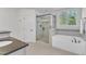 This modern bathroom is equipped with glass shower enclosure, soaking tub, and granite sink at 644 Angelica Cir, Cary, NC 27518
