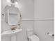 Stylish half-bathroom with pedestal sink, beadboard wainscoting, and modern fixtures at 644 Angelica Cir, Cary, NC 27518