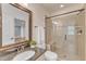 Well-lit bathroom featuring a granite vanity, a glass-enclosed shower, and modern fixtures at 644 Angelica Cir, Cary, NC 27518
