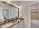 Bathroom featuring double sinks, granite countertops, and a large framed mirror at 644 Angelica Cir, Cary, NC 27518