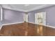 Spacious bedroom features tray ceiling, hardwood floors, and open doorway to bathroom at 644 Angelica Cir, Cary, NC 27518