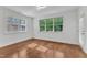 Bright bedroom features hardwood floors, white trim, and multiple windows that provide plenty of natural light at 644 Angelica Cir, Cary, NC 27518