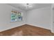 Clean bedroom with hardwood floors, large window, and recessed lighting providing a bright and modern space at 644 Angelica Cir, Cary, NC 27518
