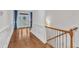 Elegant entryway featuring hardwood floors, staircase, and a glass front door with blue accents at 644 Angelica Cir, Cary, NC 27518