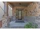 Inviting front porch with stone accents, decorative wreath, and a glass paneled front door at 644 Angelica Cir, Cary, NC 27518
