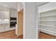 Kitchen with built-in stainless steel microwave and oven and a pantry with shelving at 644 Angelica Cir, Cary, NC 27518