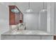 View of a kitchenette with wood cabinets, granite counters, lighting, and a stainless steel sink at 644 Angelica Cir, Cary, NC 27518